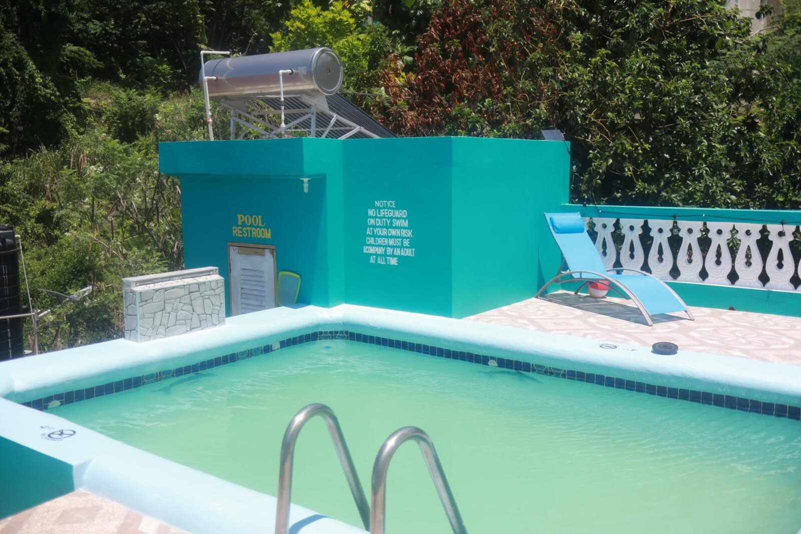 Private outdoor pool and lounge area at BayPalace Jamaica with tropical landscaping.