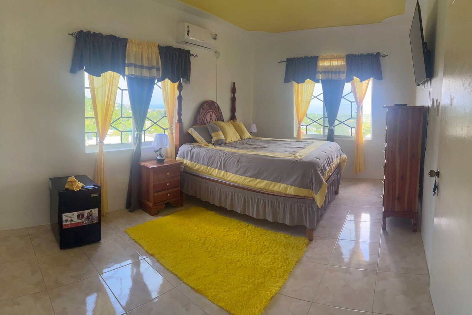 A deep red bedroom featuring elegant dark wood furniture and soft ambient lighting.