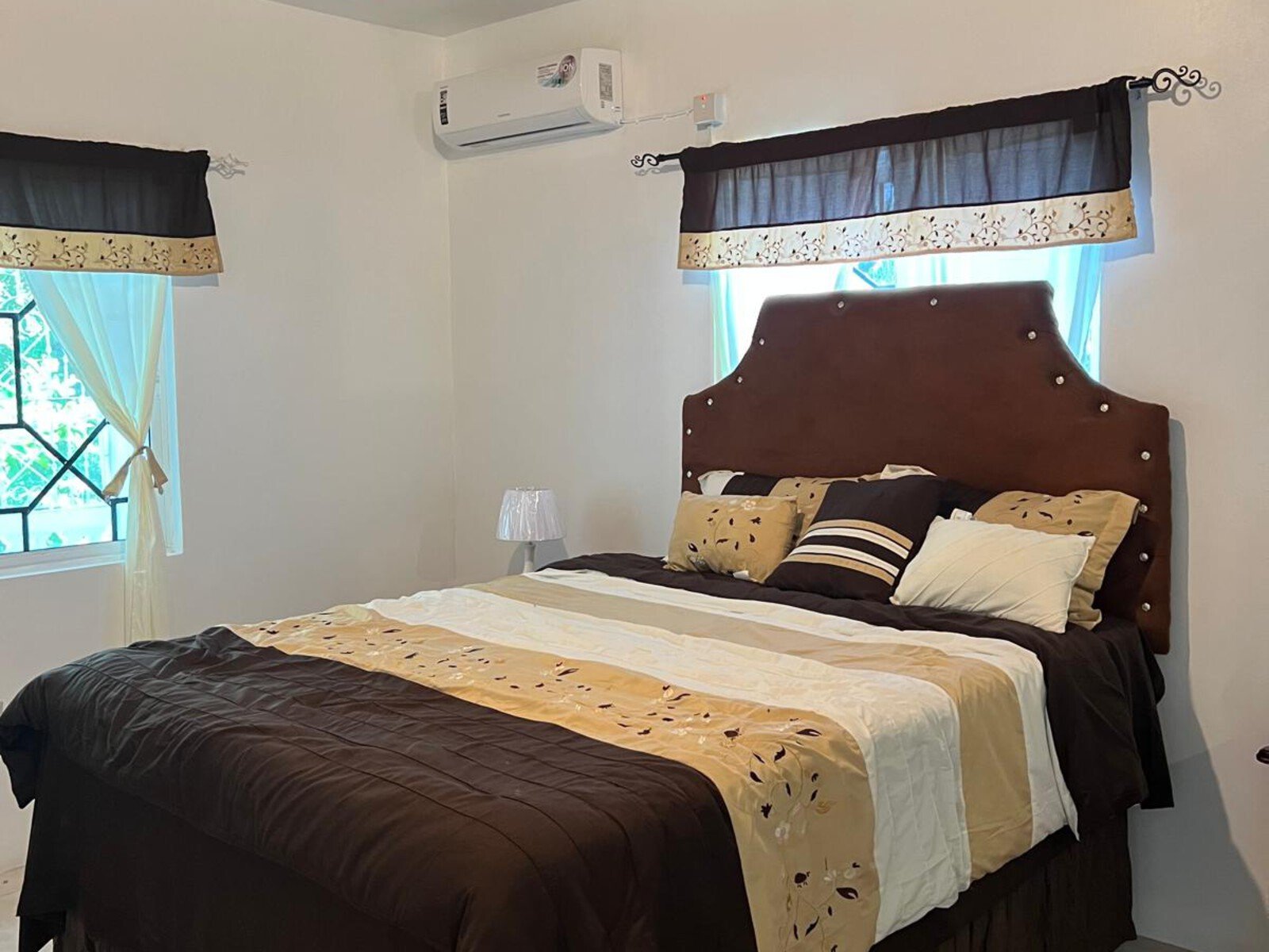 Luxury villa interior featuring a vibrant red-themed bedroom with a king-size bed.